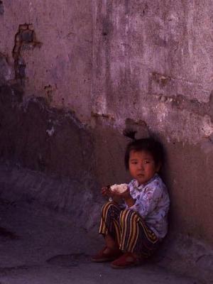 Chinese child eating in alley