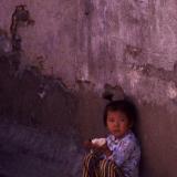 Chinese child eating in alley
