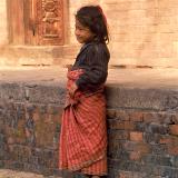 Little girl in Nepal by a wall