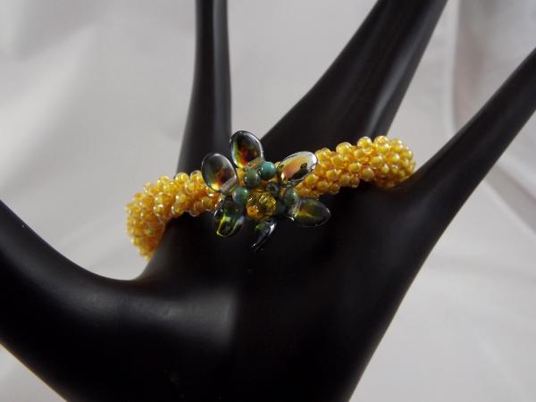 B-110 golden yellow crocheted rope bracelet w/flower