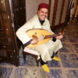 Berber musician plays lotar, La Grande Table Francaise