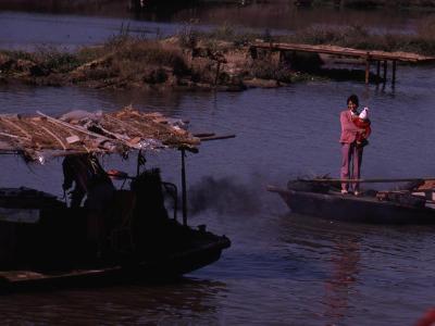 Chinese woman standing on boat