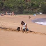 girl buried on the beach