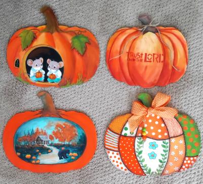Pumpkins painted on wood pumpkin shapes
