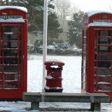 Red Phone Boxes in the Snow