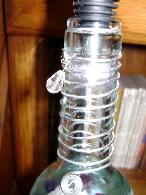 Bottle necks are embellished with metal wire,some with glass beads.