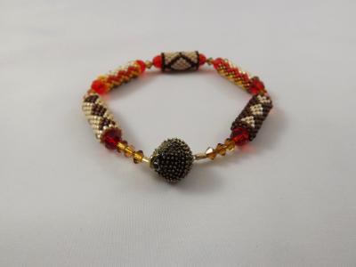 B-92 brown, orange, ecru, & amber beaded tube bracelet