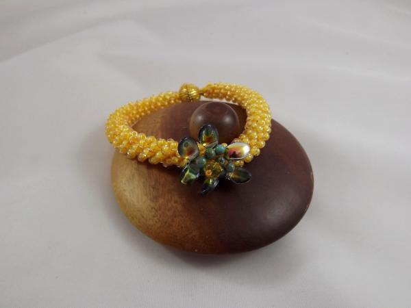 B-110 golden yellow crocheted rope bracelet w/flower