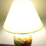 Reclaimed lamp filled with pieces of colorful straws.