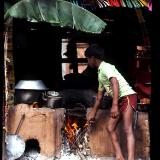 Nepalese boy stoking fire