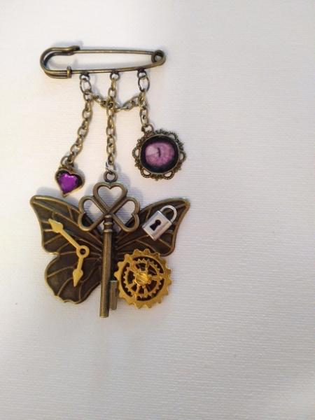 Bar pin , Key and charms with cat's eye
