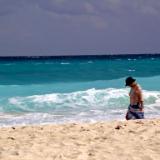 woman walks along a Cancun beach