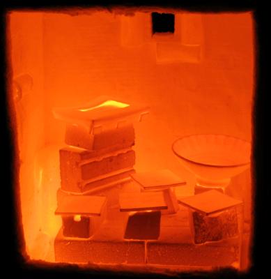 The inside of a just-opened kiln showing the pots glowing orange hot