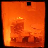 The inside of a just-opened kiln showing the pots glowing orange hot