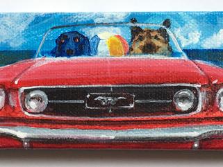 TWO DOGS IN A RED A MUSTANG  